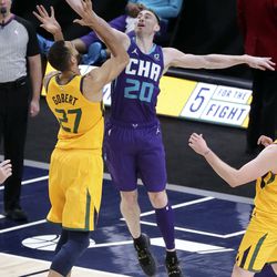 Utah Jazz center Rudy Gobert (27) and Charlotte Hornets forward Gordon Hayward (20) reach for the rebound during an NBA game at the Vivint Smart Home Arena in Salt Lake City on Monday, Feb. 22, 2021. The Jazz won 132-110.
