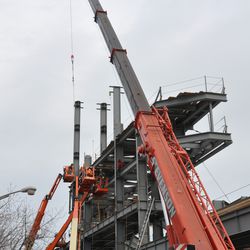 Girder being hoisted up to the jumbotron support structure - 