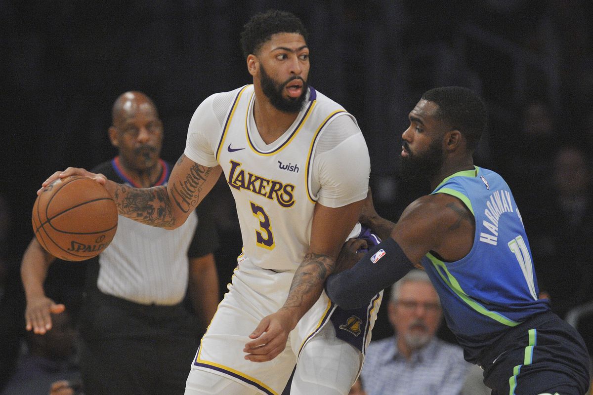 Los Angeles Lakers forward Anthony Davis controls the ball against the defense of Dallas Mavericks guard Tim Hardaway Jr. during the first half at Staples Center.