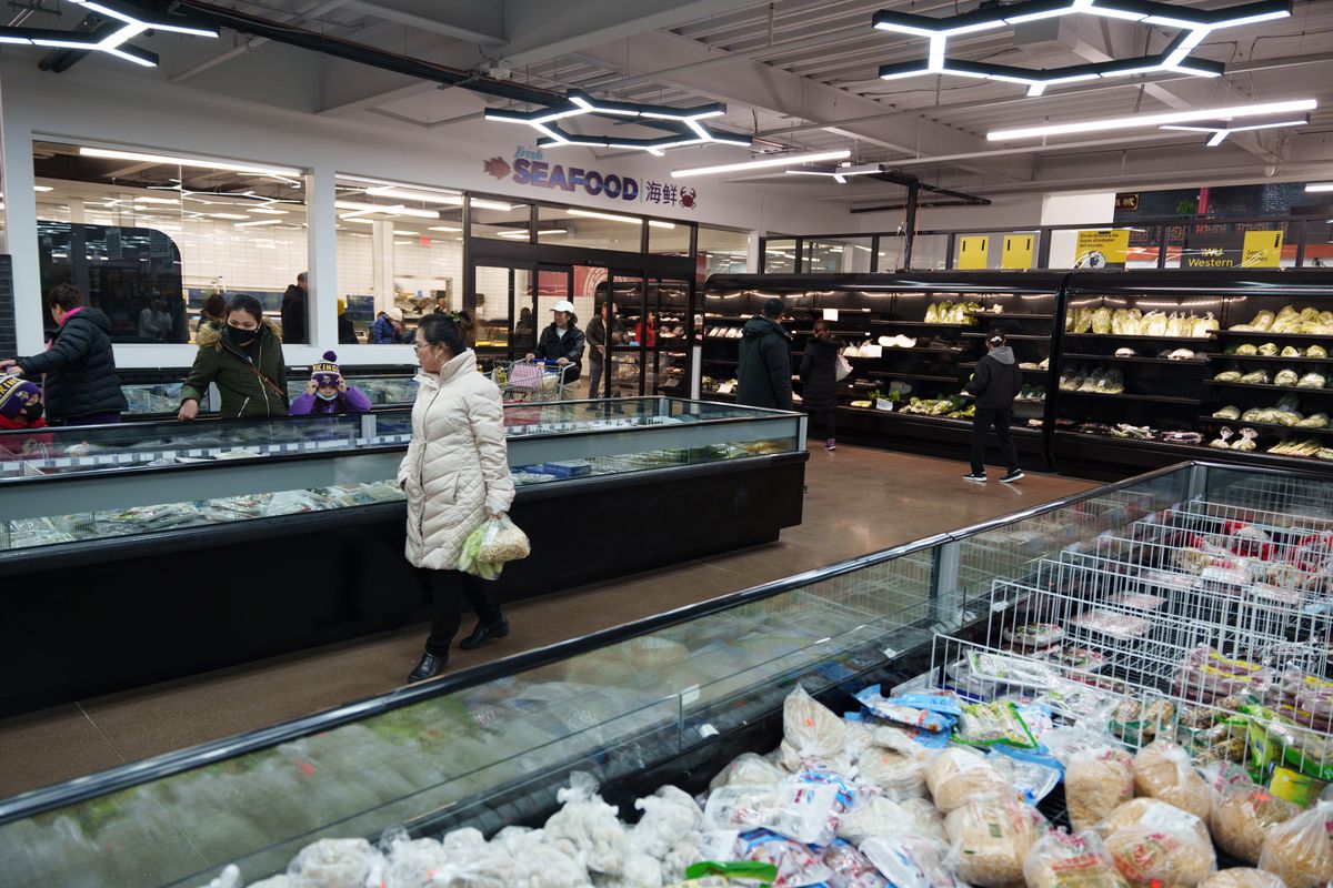 Large areas of frozen items and shoppers crowd around the shelves of Asian Mart 88. 