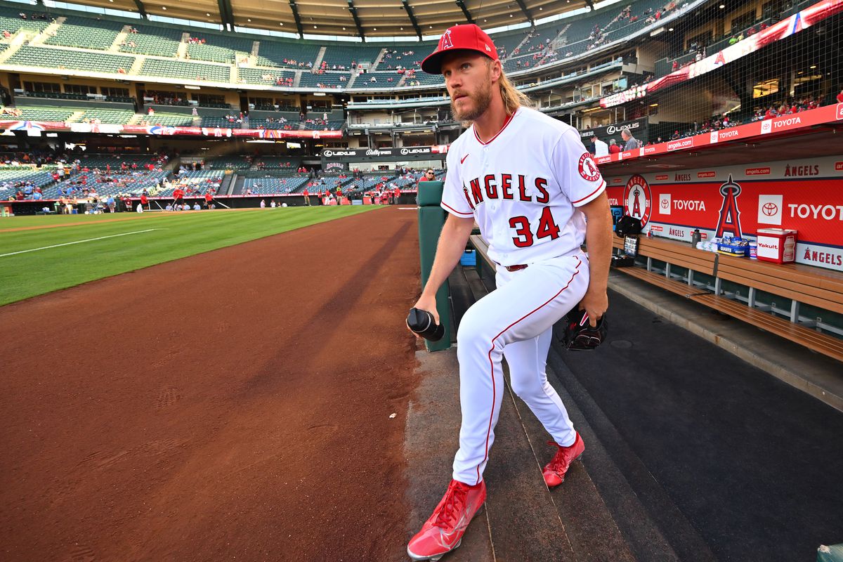 Noah Syndergaard #34 of the Los Angeles Angels heads out of the dugout to warm up for the game against the Kansas City Royals at Angel Stadium of Anaheim on June 20, 2022 in Anaheim, California.
