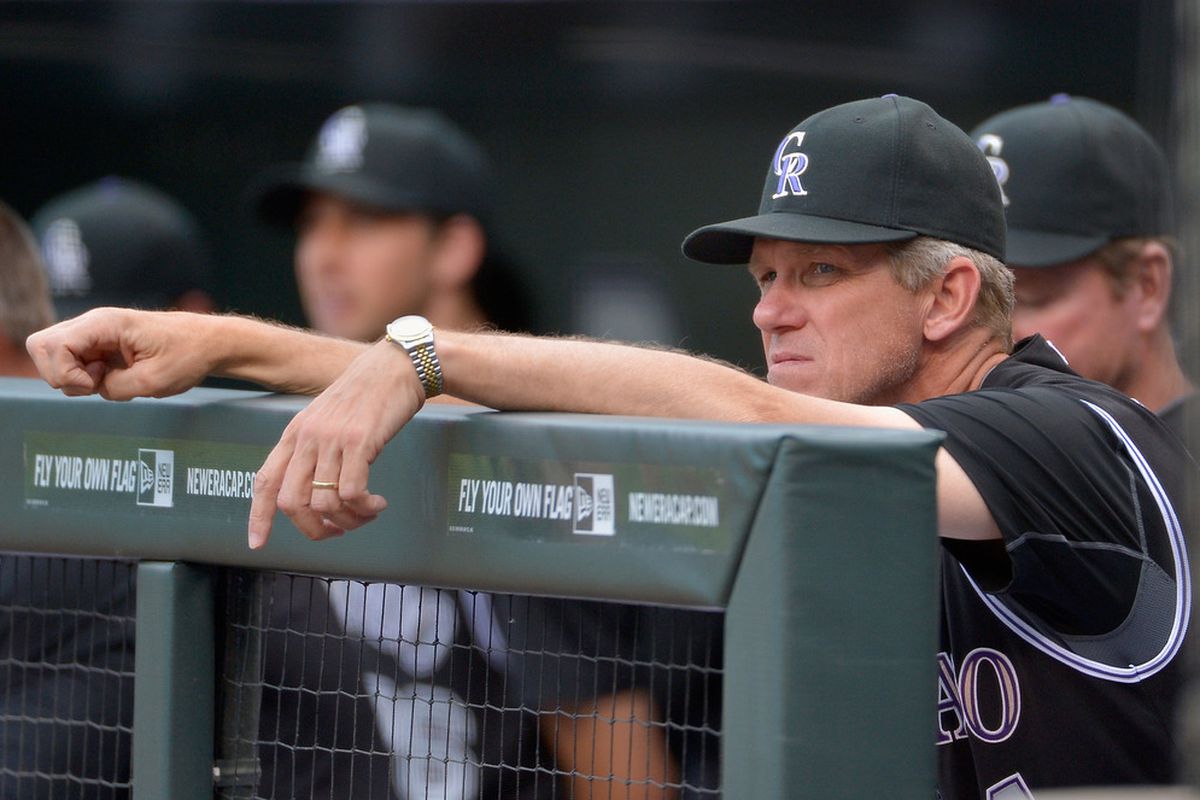 Manager Jim Tracy of the Colorado Rockies looks on from the dugout as his team faces the Oakland Athletics during Interleague Play at Coors Field in Denver, Colorado.  (Photo by Doug Pensinger/Getty Images)