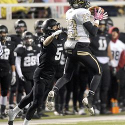 Desert Hills' Jordan Hokanson makes an interception in front of Pine View's Jack Bangerter that would set up the game winning drive during the 3AA State Championships at Rice-Eccles Stadium on Friday, November 22, 2013.