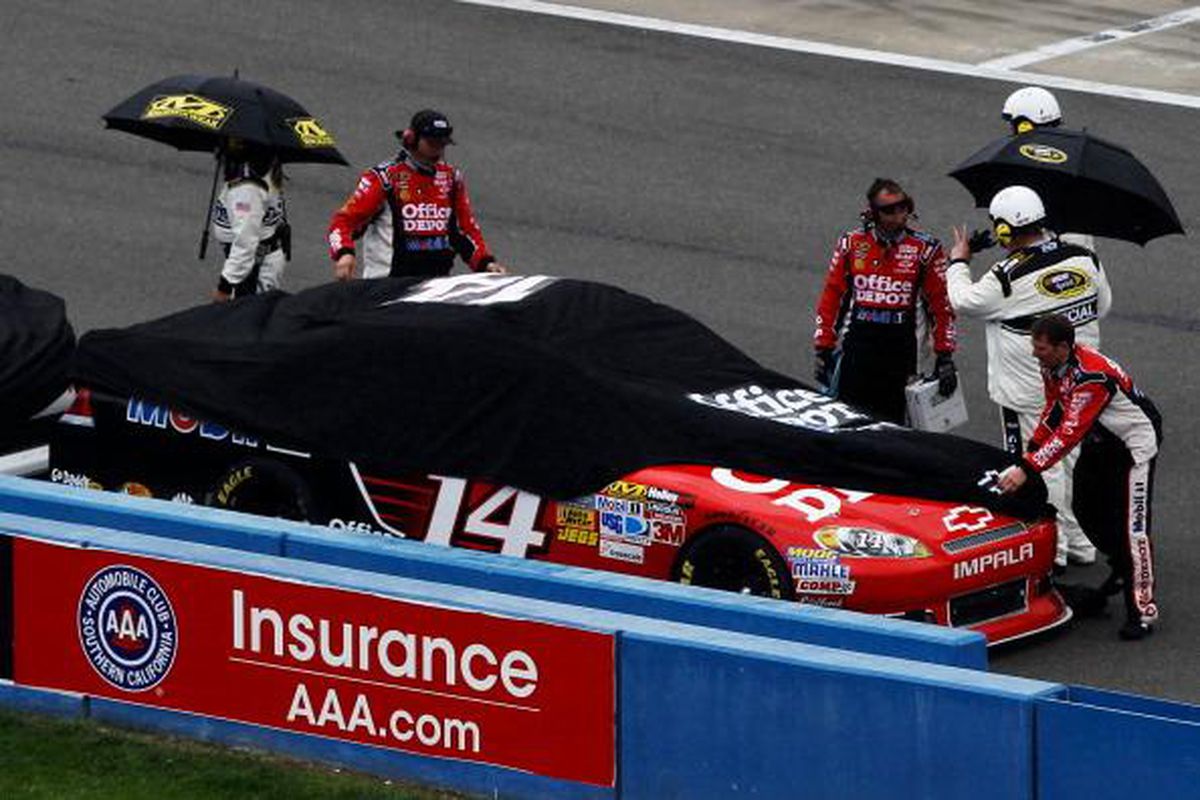 Tony Stewart's No. 14 Chevrolet takes cover from the rain.