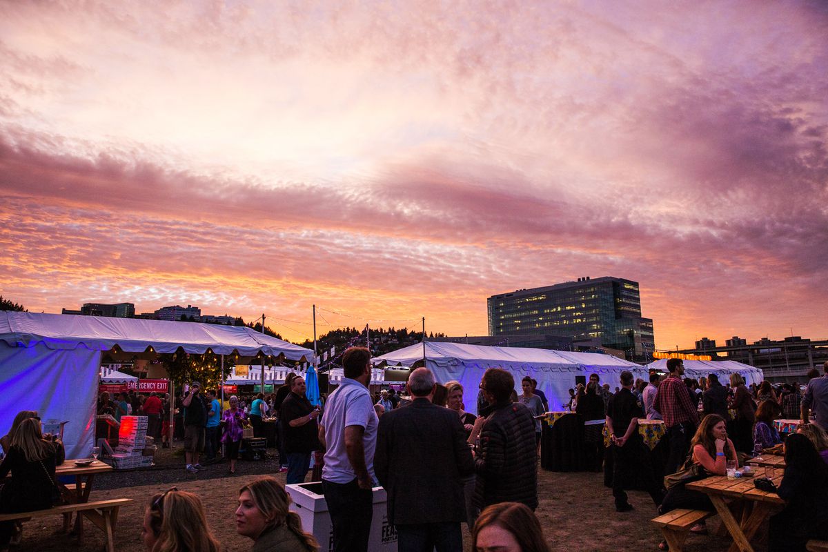Diners stroll and wait at food stalls at sunset in a 2015 Feast event.