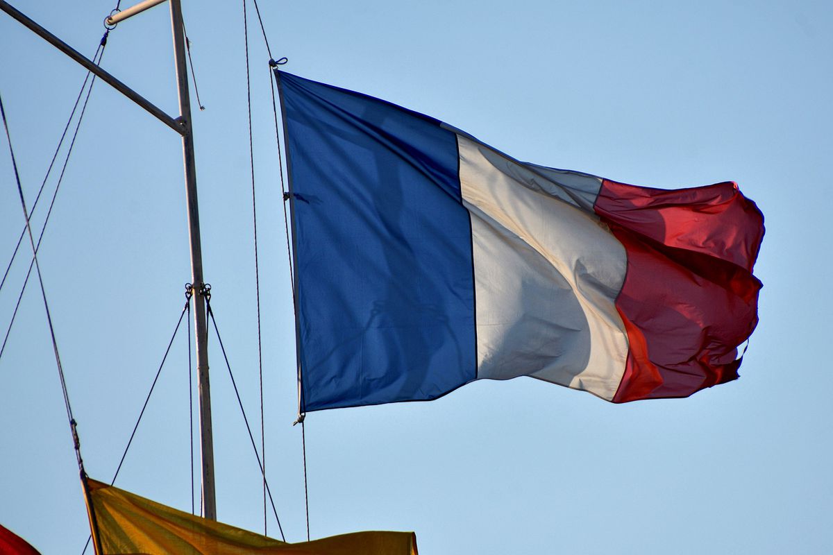 A French flag is flying from the mast of a boat in Marseille...