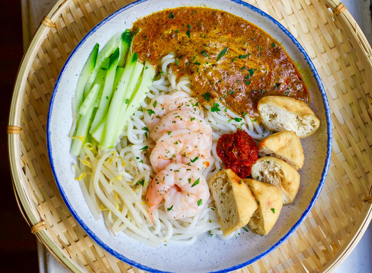 A noodle dish with pieces of shrimp and a brown sauce