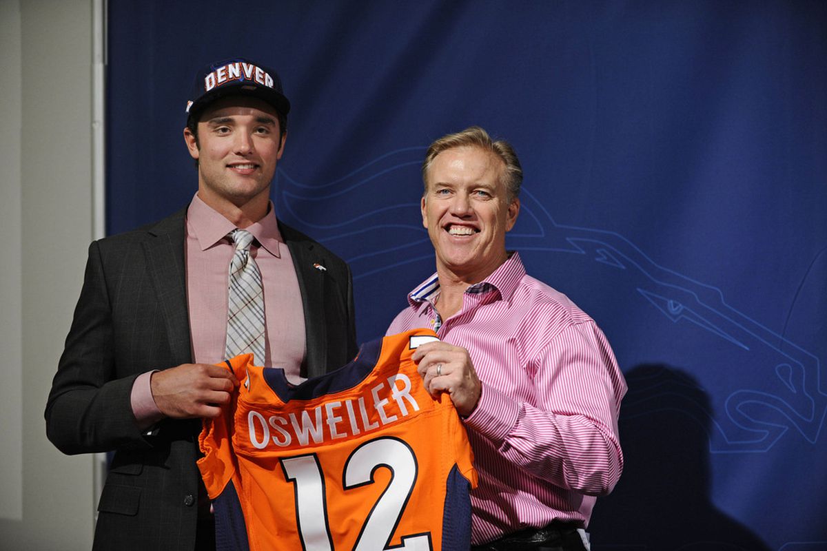 April 28 2012; Englewood, CO, USA; Denver Broncos executive vice president of football operations John Elway poses for a photo with second round draft pick quarterback Brock Osweiler at Broncos headquarters. Mandatory Credit: Ron Chenoy-US PRESSWIRE