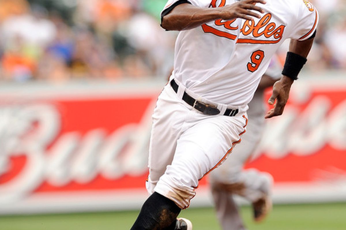 BALTIMORE - JUNE 13:  Miguel Tejada #9 of the Baltimore Orioles rounds third base and scores in the first inning against the New York Mets at Camden Yards on June 13, 2010 in Baltimore, Maryland.  (Photo by Greg Fiume/Getty Images)