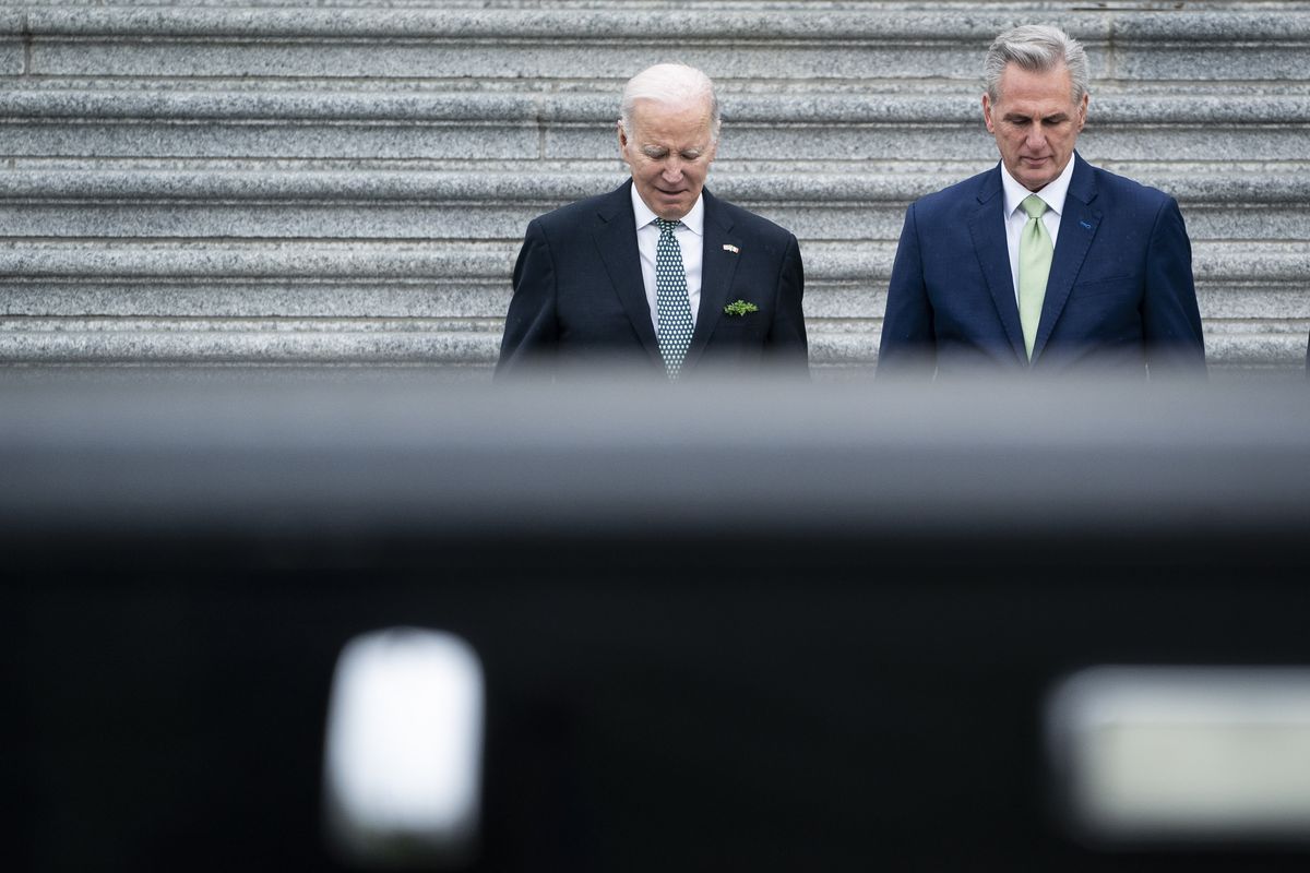 Biden and McCarthy walk down steps. 