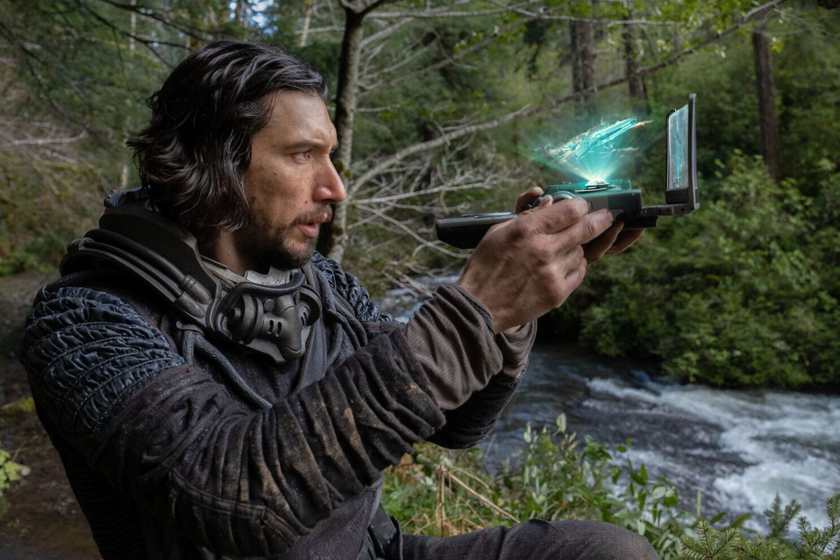 Adam Driver as Mills interacting with an alien telescope in a forest in 65.