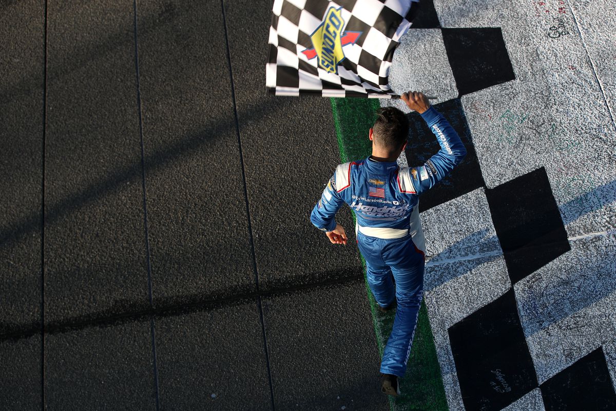 Kyle Larson, driver of the #5 HendrickCars.com Chevrolet, celebrates with the checkered flag after winning the NASCAR Cup Series Wise Power 400 at Auto Club Speedway on February 27, 2022 in Fontana, California.