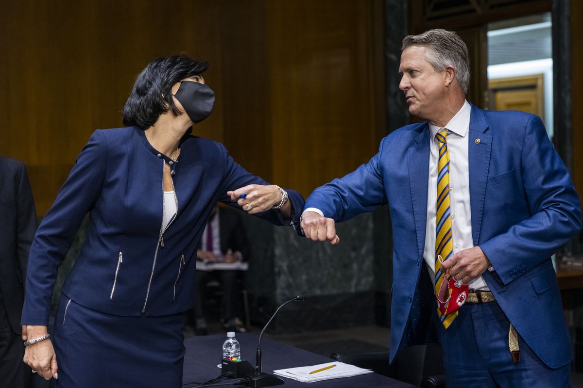 Dr. Rochelle Walensky, left, director of the U.S. Centers for Disease Control and Prevention, greets Sen. Roger Marshall, R-Kansas, right, on Tuesday.
