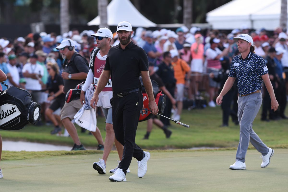 Dustin Johnson, center, and Cameron Smith right, walk the 18th hole during LIV Golf Team Championship, on October 30, 2022 at Trump National Doral Golf Club in Doral, FL.