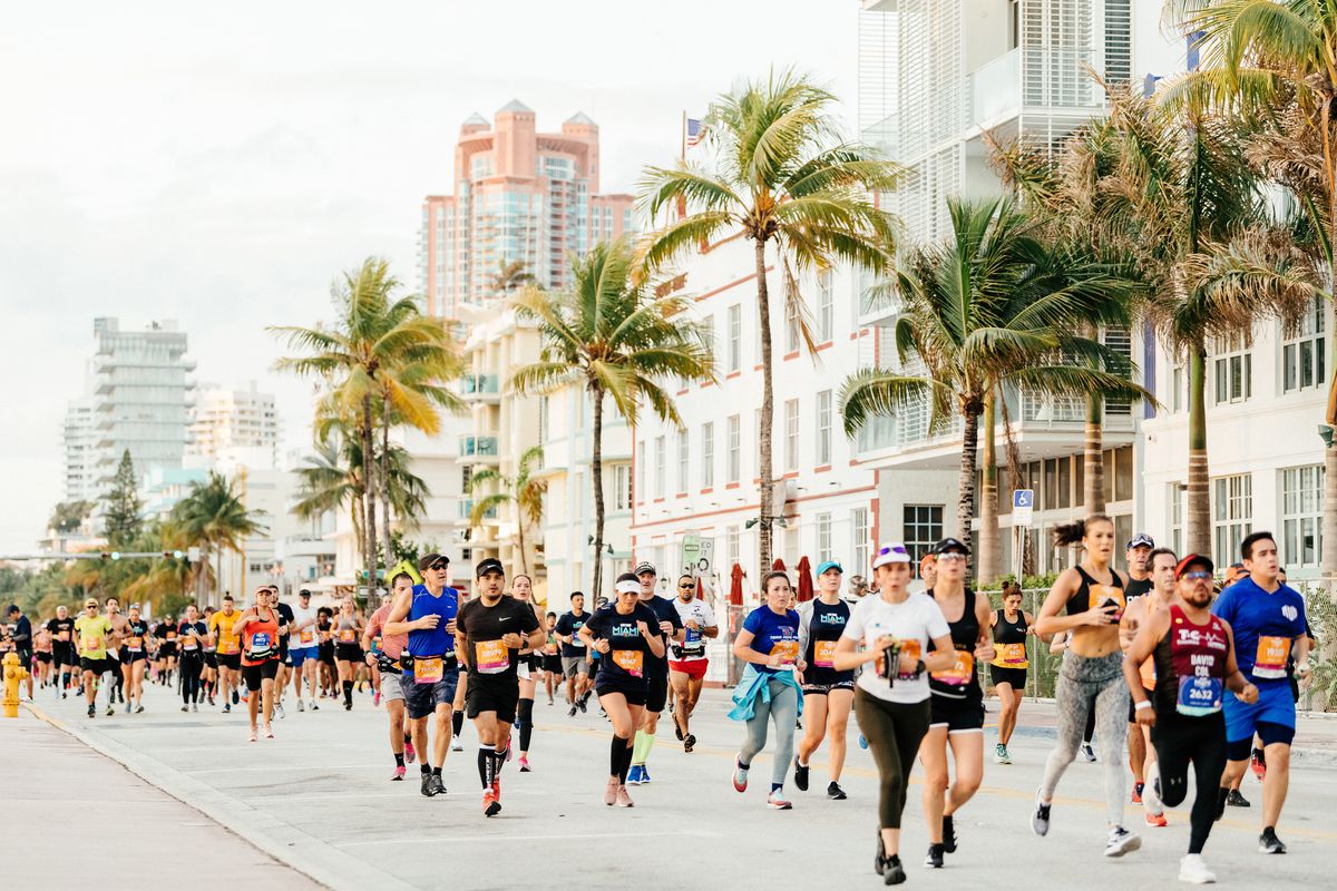 Miami Marathon runners running along the beach.