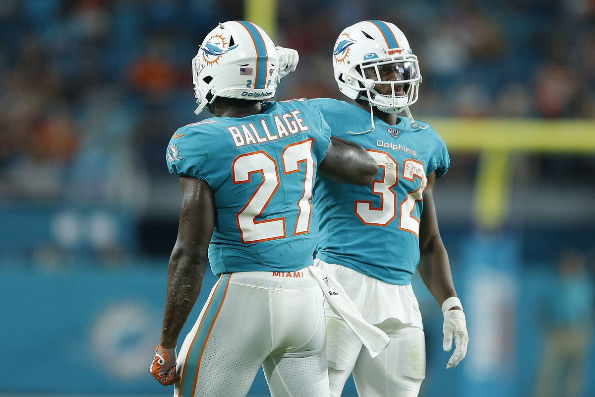 Kalen Ballage of the Miami Dolphins celebrates with Kenyan Drake after scoring a touchdown against the Atlanta Falcons during the first quarter of the preseason game at Hard Rock Stadium on August 08, 2019 in Miami, Florida.