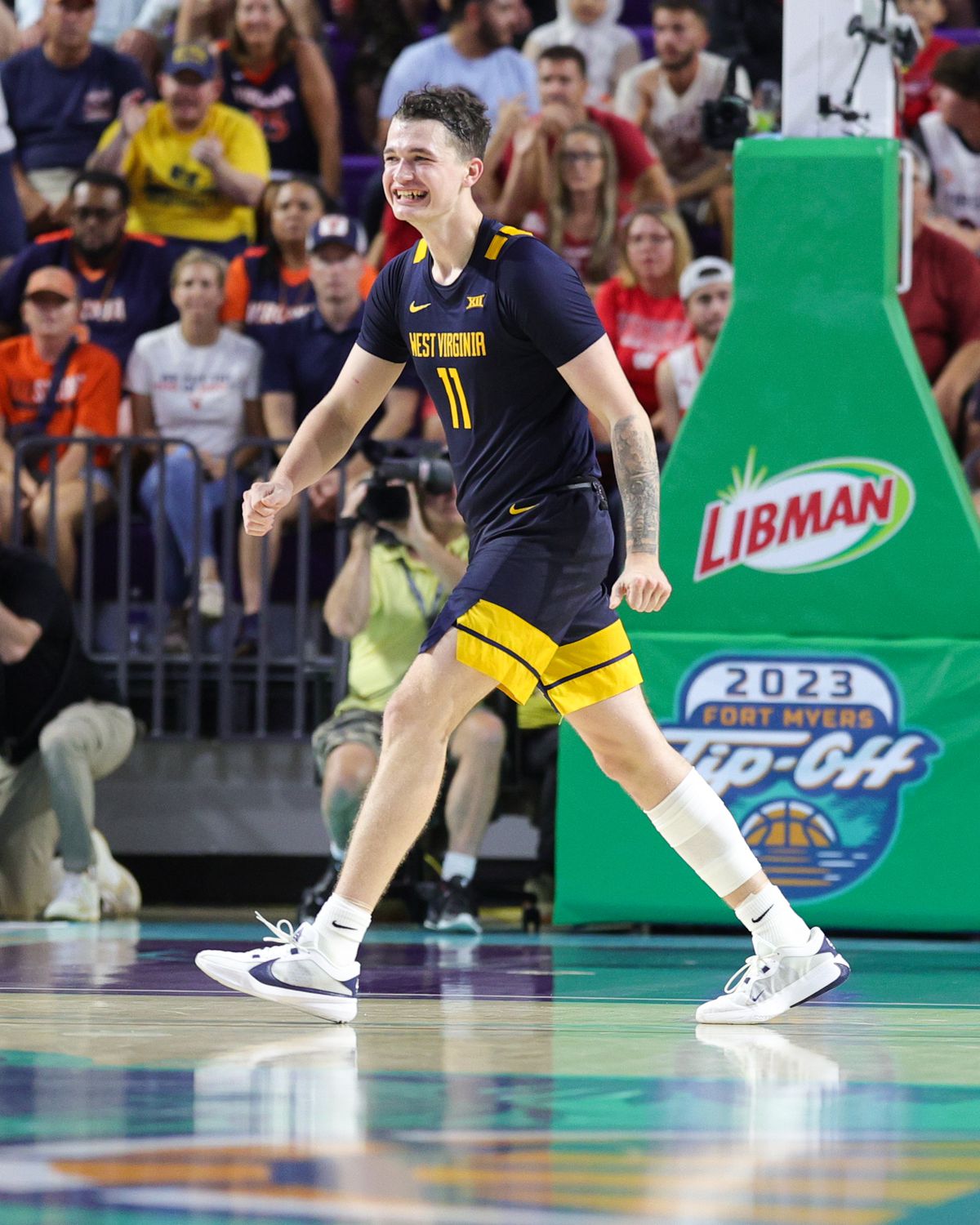 West Virginia Mountaineers forward Quinn Slazinski (11) reacts after a play against the Virginia Cavaliers in the second half during the Fort Myers Tip-Off third place game at Suncoast Credit Union Arena