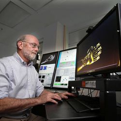 Associate professor Gregory A. Clark of the University of Utah Department of Bioengineering works to determine the capabilities of the Utah Slanted Electrode Array in Salt Lake City, Monday, Feb. 9, 2015.