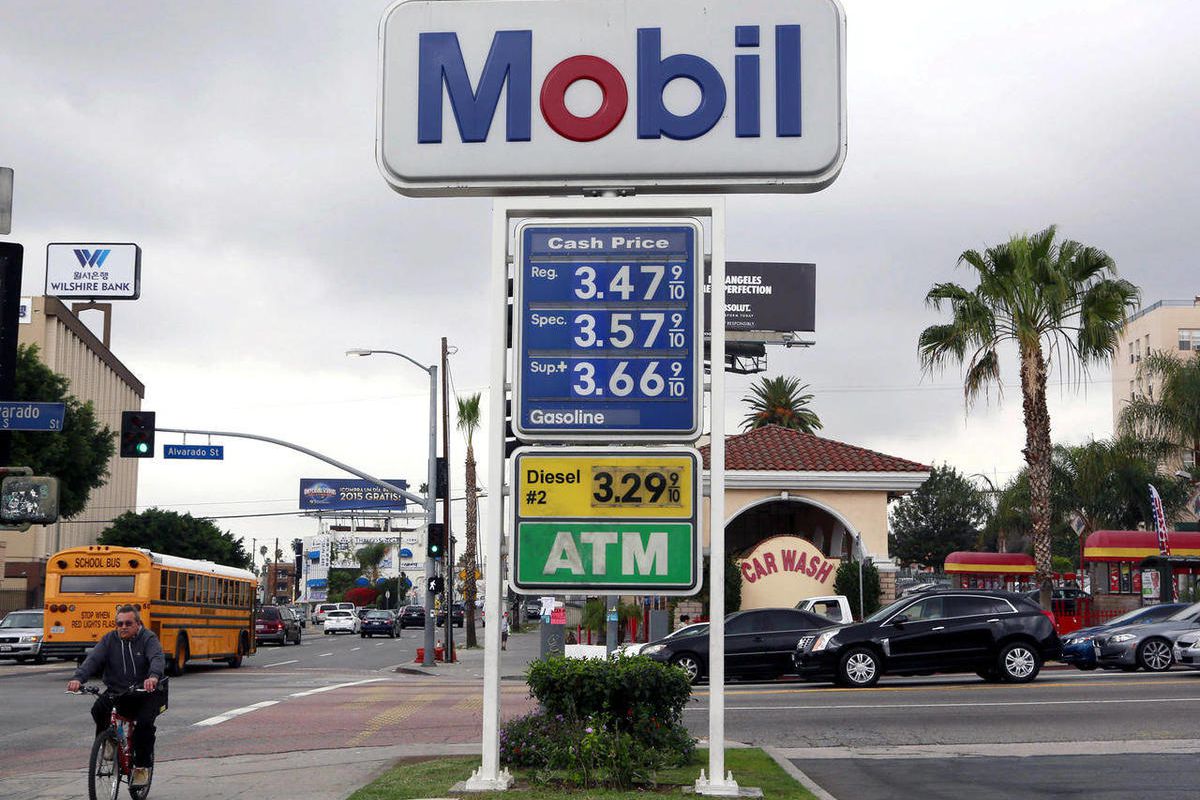 A cyclist rides by a sign at a gas station in Los Angeles posting the latest gas prices on Friday, Feb. 27, 2015. Gas prices in California soared overnight as a result of a combination of supply-and-demand factors worsened by the shutdown of two refinerie