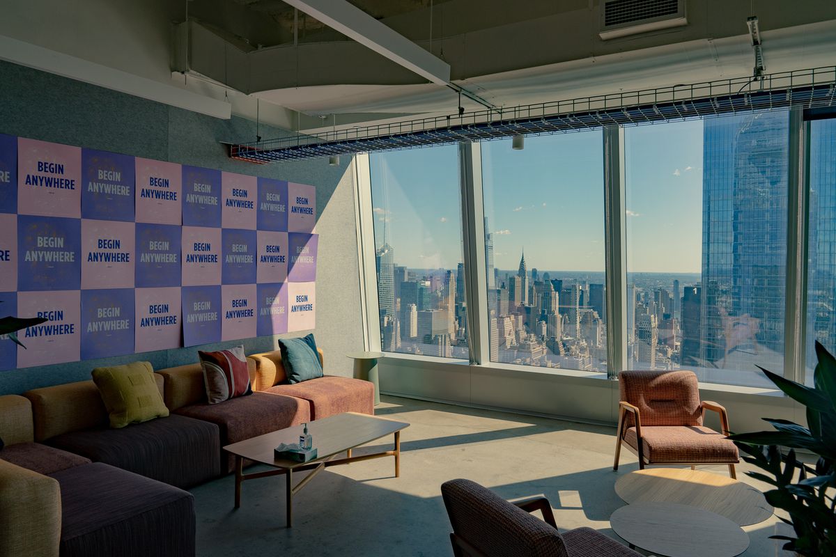 Empty chairs sit in Meta’s New York office with a view of the city.