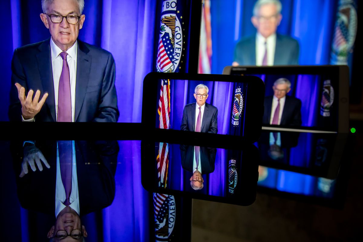 The Fed chair speaking pictured on various screens.