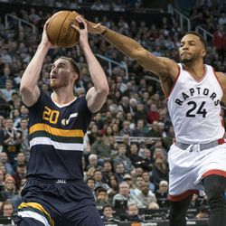 Toronto guard Norman Powell (24) gets his hand on the ball possessed by Utah forward Gordon Hayward (20) during an NBA basketball game in Salt Lake City on Friday, Dec. 23, 2016. Toronto took down Utah with a final score of 104-98.