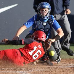 Utah's Alyssa Barrera slides safe into home plate as BYU's catcher Libby Sugg loses the ball as BYU and Utah play a softball game at BYU in Provo on Wednesday, May 1, 2019. Utah won 11-2.