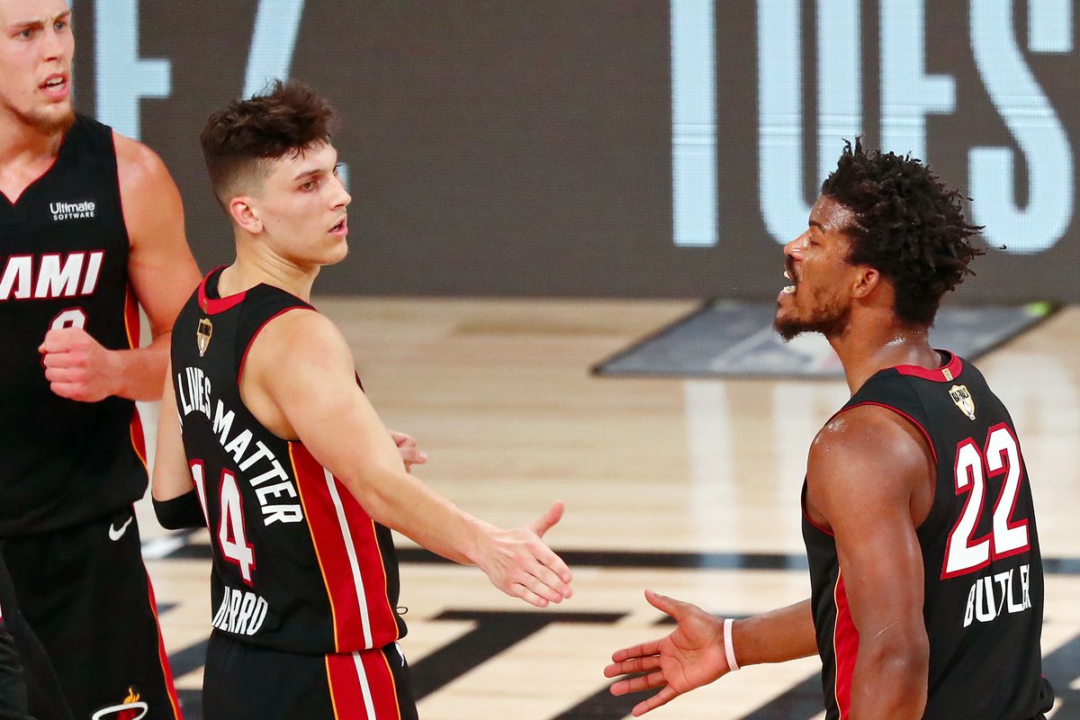 Miami Heat forward Jimmy Butler reacts after a play against the Los Angeles Lakers as he high fives guard Tyler Herro during the fourth quarter of game three of the 2020 NBA Finals at AdventHealth Arena. The Miami Heat won 115-104.