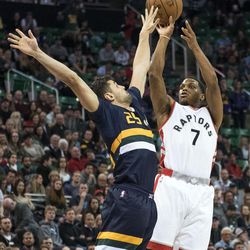 Toronto guard Kyle Lowry (7) shoots over Utah guard Raul Neto (25) during an NBA basketball game in Salt Lake City on Friday, Dec. 23, 2016. Toronto took down Utah with a final score of 104-98.