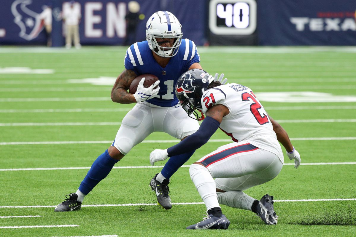 Michael Pittman Jr. #11 of the Indianapolis Colts stiff arms Steven Nelson #21 of the Houston Texans during the second quarter at NRG Stadium on September 11, 2022 in Houston, Texas.