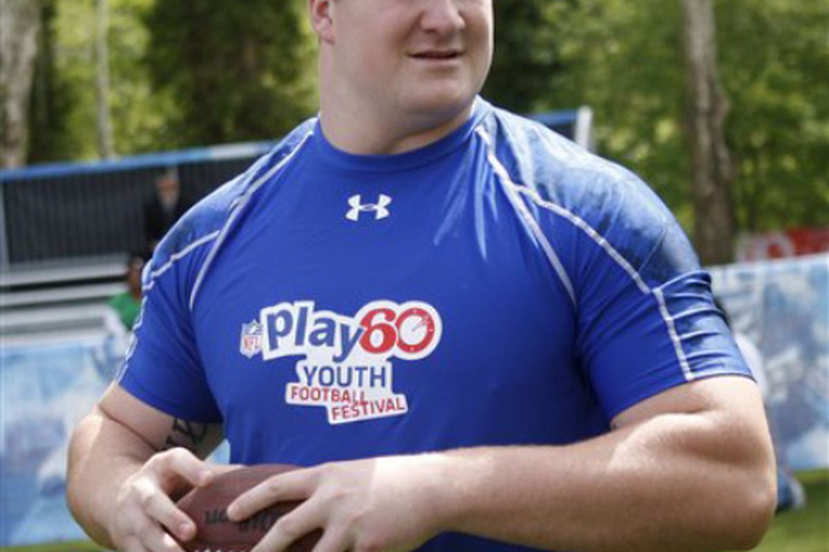 NFL draft prospect Bryan Bulaga, of Iowa, plays football with some youngsters during a youth football clinic at Central Park in New York, Wednesday, April 21, 2010.  (AP Photo/Seth Wenig)