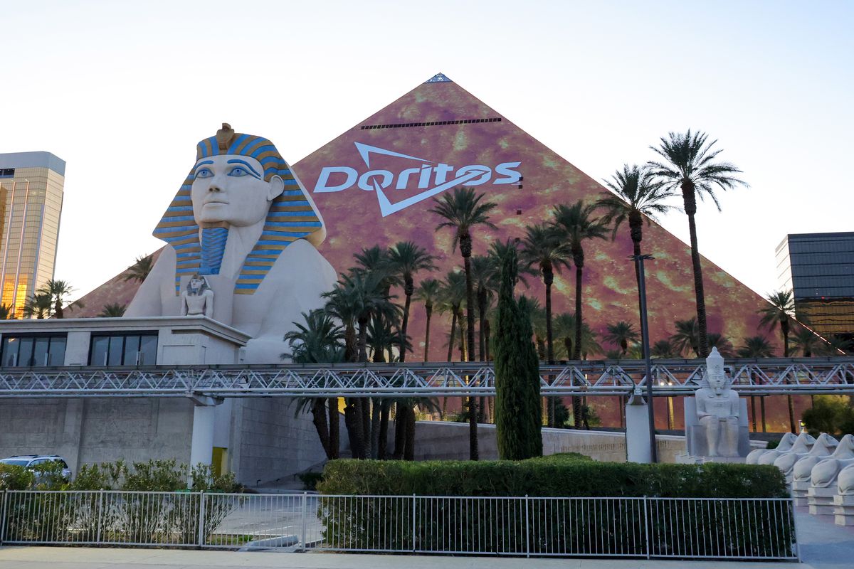 The triangular, Las Vegas Strip side of Luxor Hotel and Casino is covered in an orange advertisement for Doritos ahead of Super Bowl LVIII on January 30, 2024 in Las Vegas, Nevada. The game will be played on February 11, 2024, between the Kansas City Chiefs and the San Francisco 49ers at Allegiant Stadium.