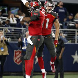 Tampa Bay Buccaneers' Jameis Winston, left, and Adam Humphries, right, celebrate a touchdown catch by Humphries in the second half of an NFL football game against the Dallas Cowboys on Sunday, Dec. 18, 2016, in Arlington, Texas. 