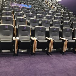 The football team room might as well be a movie theater, except it has one thing that those don’t - the coaches can lower a divider in order to split the room into offense and defense for smaller meetings.