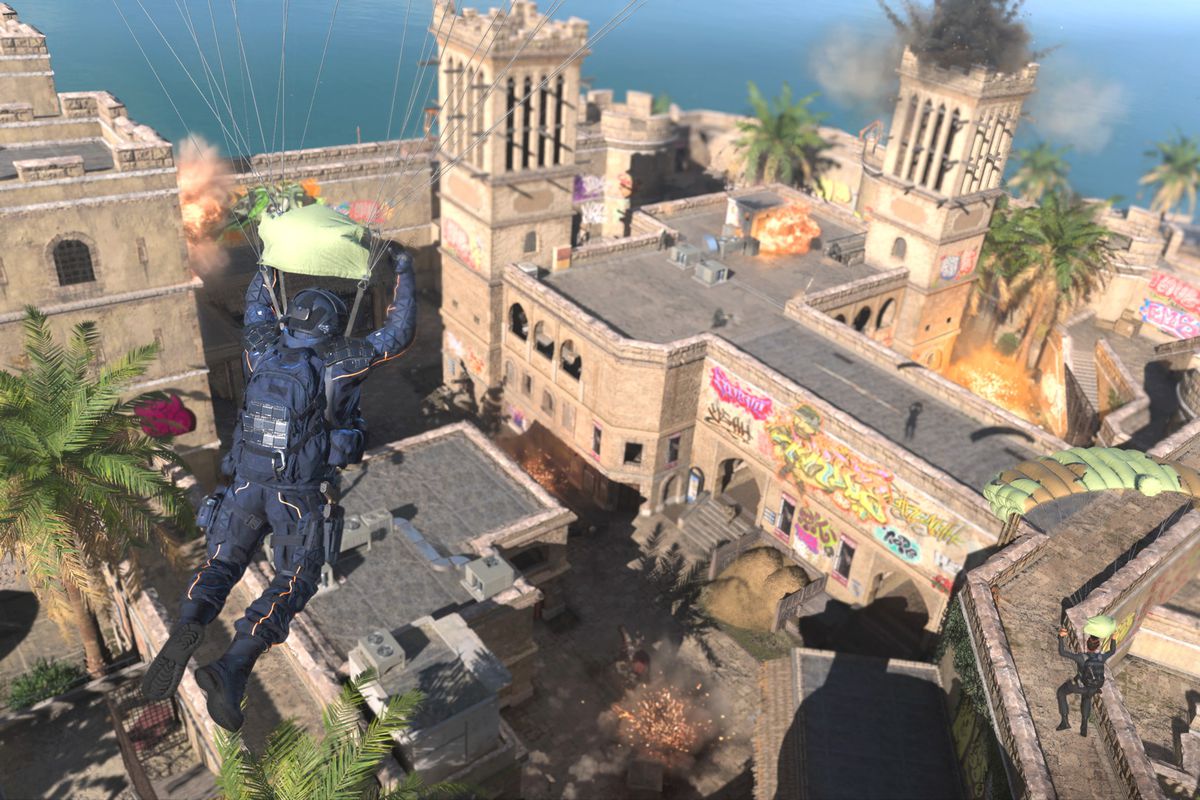 A soldier in blue armor skydivers toward an exploding building in key art for Call of Duty Modern Warfare 2: Warzone 2.