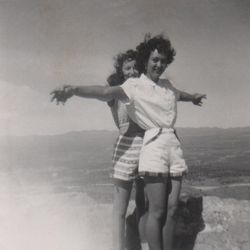 "Models" Twila Van Leer and friend, Rose Marie Condie, pose atop Lime Hill in Pioche, Nevada, ca. 1949.