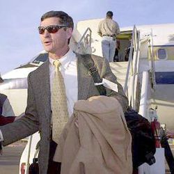 Pittsburgh coach Walt Harris, center, is greeted by Insight.com Bowl princesses as he steps off the plane at Sky Harbor Airport in Phoenix, Saturday, Dec. 23, 2000. Pittsburgh will play Iowa State in the Insight.com Bowl on Thursday.