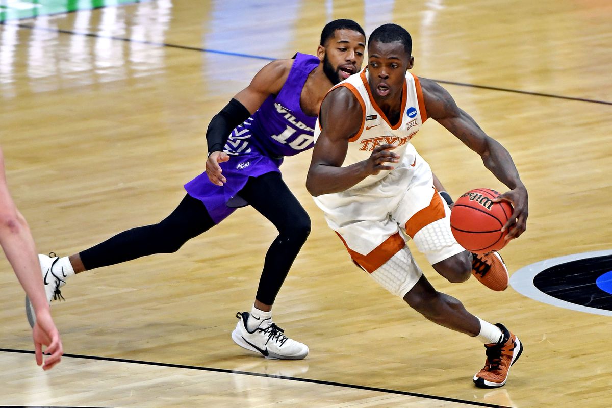 Texas Longhorns guard Andrew Jones (1) drives to the basket again Abilene Christian Wildcats guard Reggie Miller (10) during the second half in the first round of the 2021 NCAA Tournament at Lucas Oil Stadium.