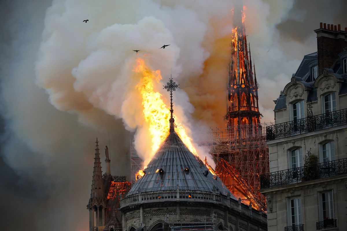 Smoke and flames rise during a fire at the Notre Dame Cathedral in central Paris on April 15, 2019, potentially involving renovation work being carried out at the site, the fire service said.