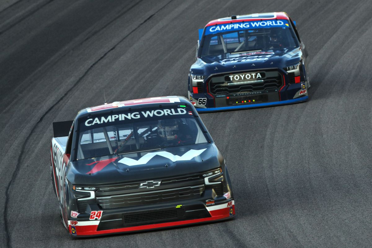 Jack Wood, driver of the #24 Sevwins Chevrolet, and Ty Majeski, driver of the #66 Road Ranger Toyota, race during the NASCAR Camping World Truck Series Kansas Lottery 200 at Kansas Speedway on September 09, 2022 in Kansas City, Kansas.