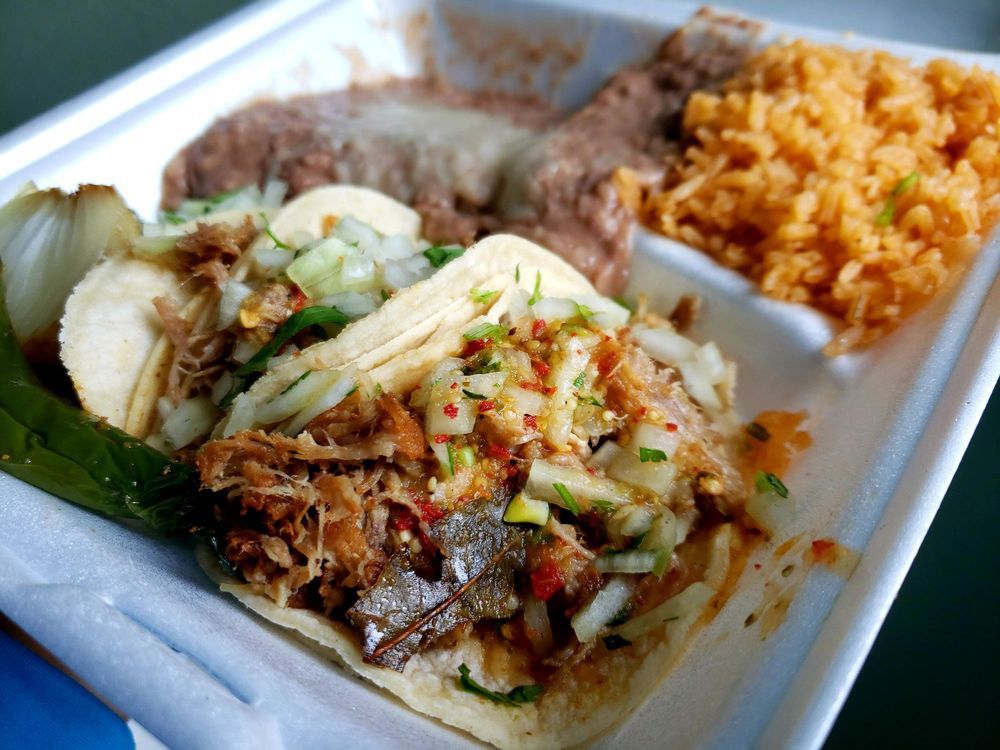 Tacos with sides in a white container from Taqueria la Fondita