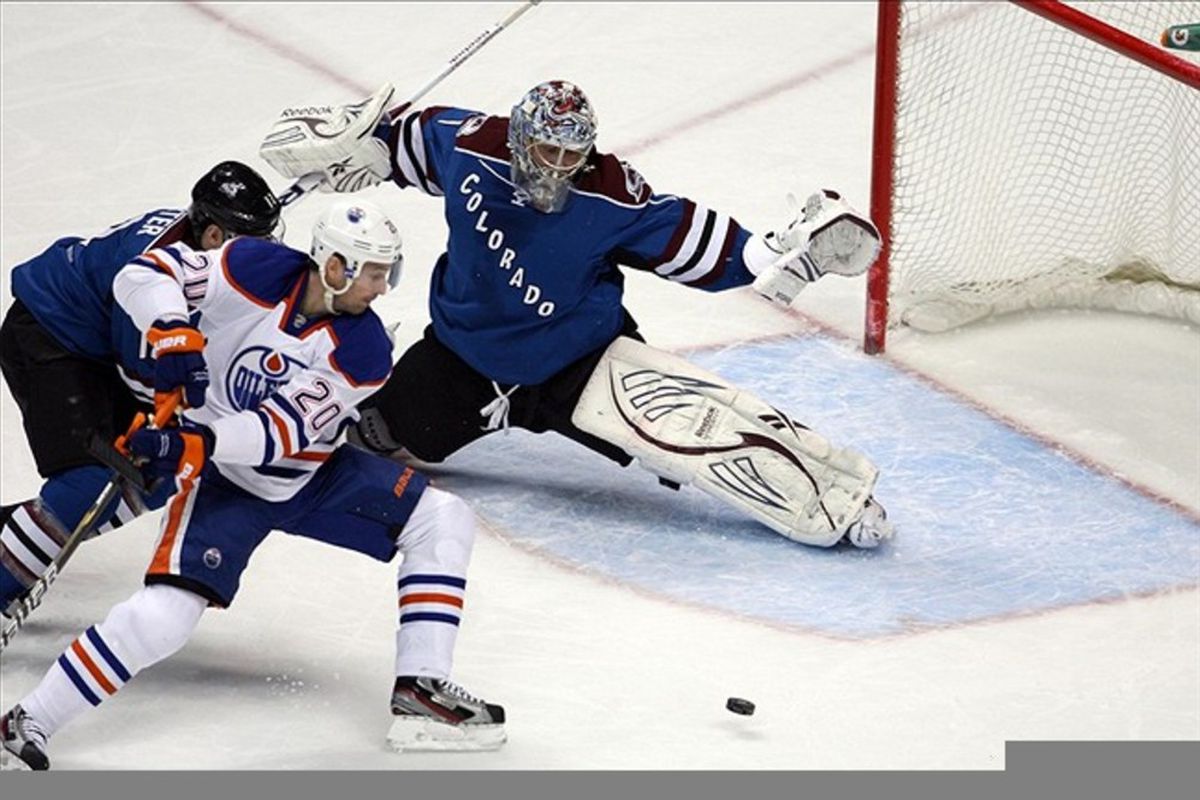 March 10, 2012; Denver, CO, USA; Colorado Avalanche goalie Semyon Varlamov (1) blocks a shot from Edmonton Oilers  center Eric Belanger (20) during the first period at the Pepsi Center.  Mandatory Credit: Chris Humphreys-US PRESSWIRE
