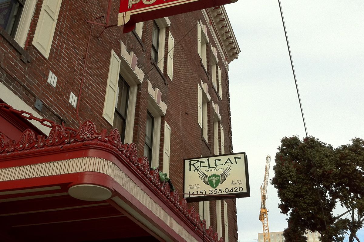 A “Releaf” dispensary sign on the side of a SoMa hotel.