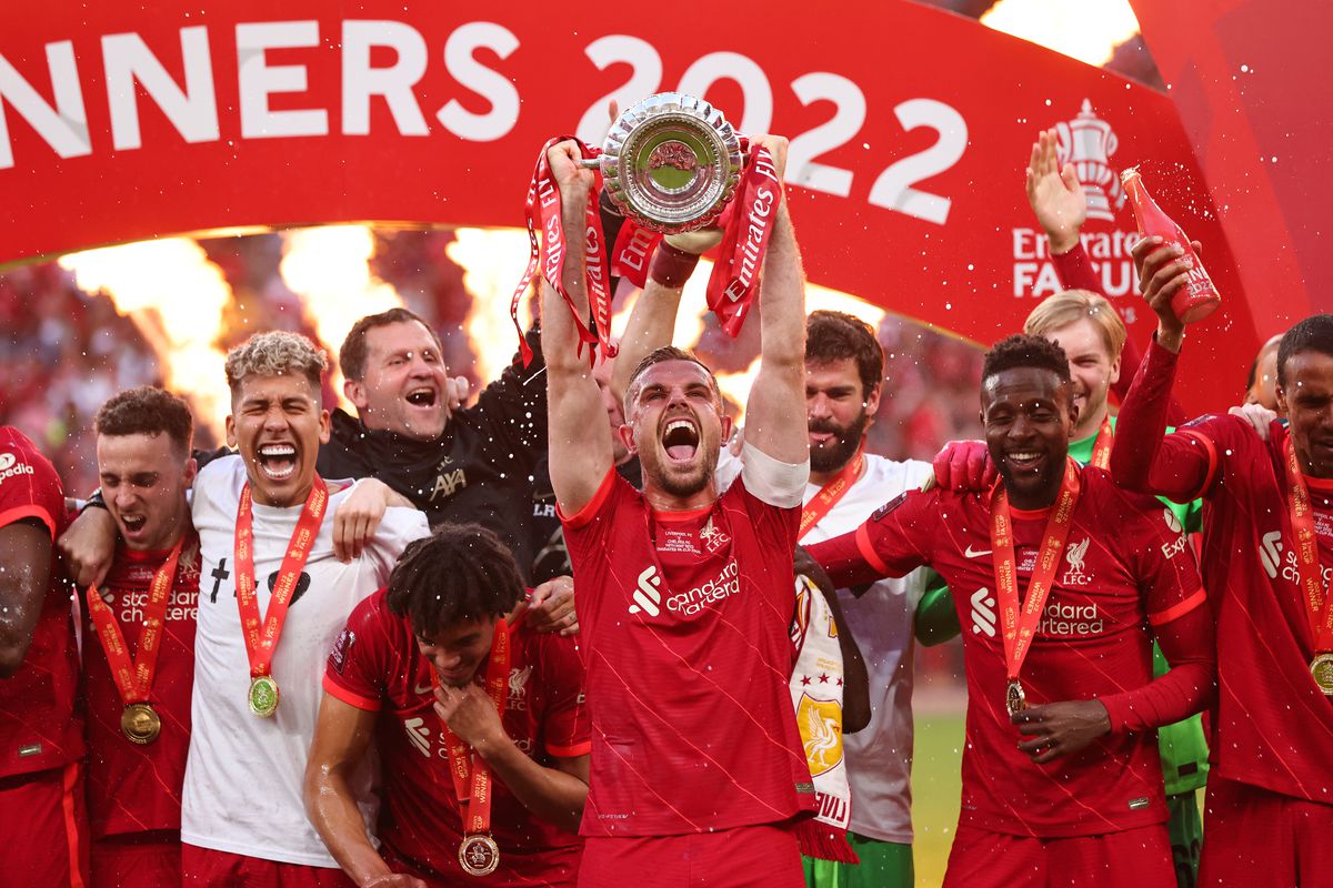 Jordan Henderson of Liverpool lifts Emirates FA Cup trophy following his team’s victory in The FA Cup Final match between Chelsea and Liverpool at Wembley Stadium on May 14, 2022 in London, England.