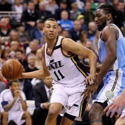 Utah Jazz guard Dante Exum (11) passes around Denver Nuggets forward Kenneth Faried (35) as the Utah Jazz and the Denver Nuggets play Wednesday, April 1, 2015, at EnergySolutions arena in Salt Lake City.