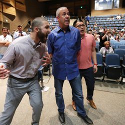 Draper residents react as Draper Mayor Troy Walker rescinds his offer of land for a homeless center during a meeting at Draper Park Middle School on Wednesday, March 29, 2017.