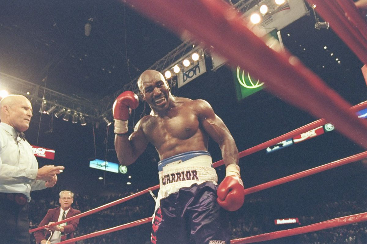 Evander Holyfield grabs his ear after getting bit by Mike Tyson in their 1997 rematch.