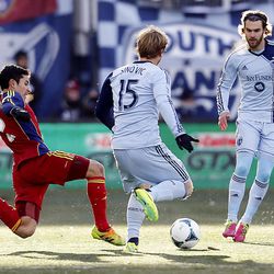 RSL's Tony Beltran tries to kick the ball away from Sporting's Seth Sinovic as Real Salt Lake and Sporting KC play Saturday, Dec. 7, 2013 in MLS Cup action.