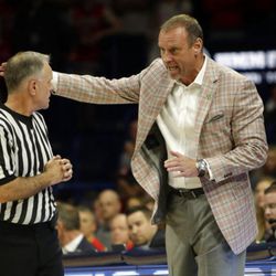 Utah head coach Larry Krystkowiak, right, talks with official Dick Cartmell in the first half during an NCAA college basketball game against Arizona, Saturday, Jan. 27, 2018, in Tucson, Ariz. (AP Photo/Rick Scuteri)