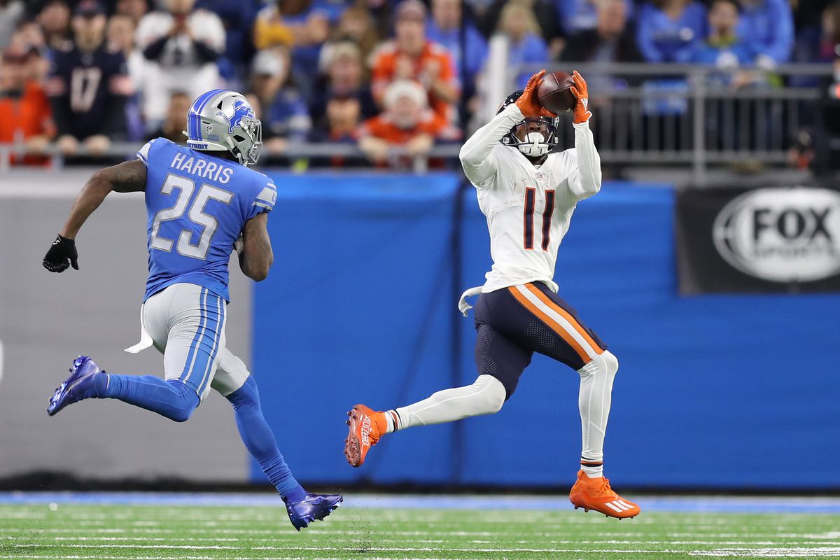 Darnell Mooney #11 of the Chicago Bears catches a pass over Will Harris #25 of the Detroit Lions during the second quarter at Ford Field on November 25, 2021 in Detroit, Michigan.